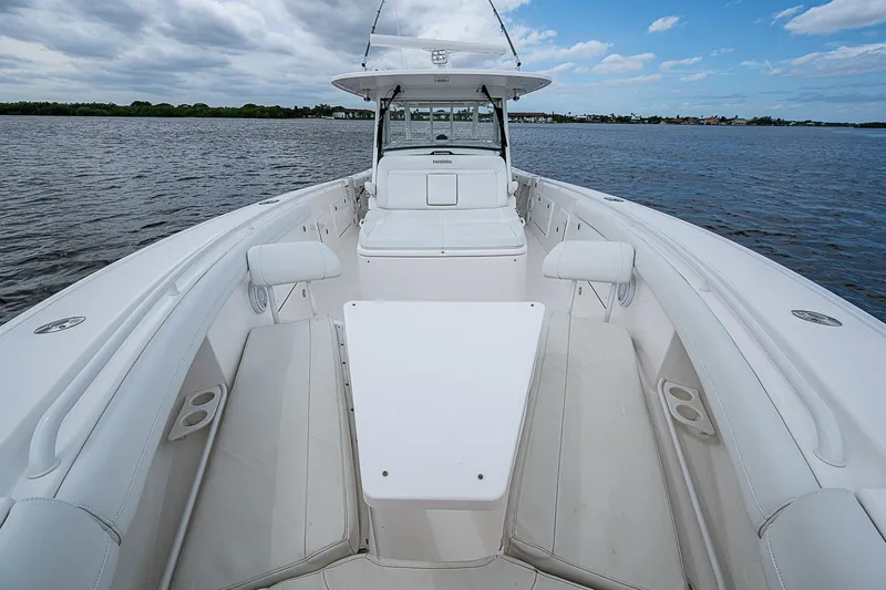 Riptide Yacht Photos Pics 2018 Everglades 435 Center Console boat on calm water under a partly cloudy sky.