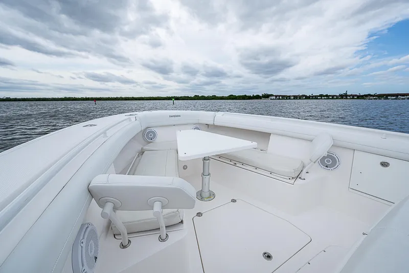 Riptide Yacht Photos Pics 2018 Everglades 435 Center Console boat with spacious seating and table on open water.