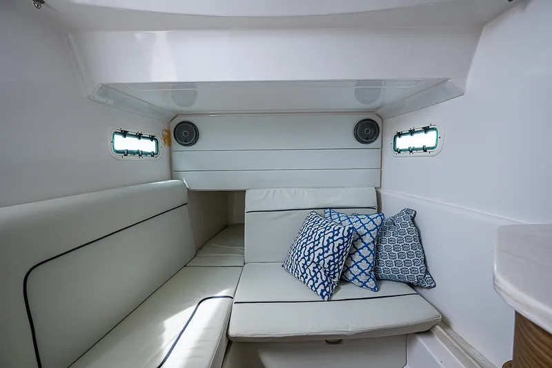 Riptide Yacht Photos Pics Interior cabin of 2018 Everglades 435 Center Console with cushioned seating and decorative pillows.