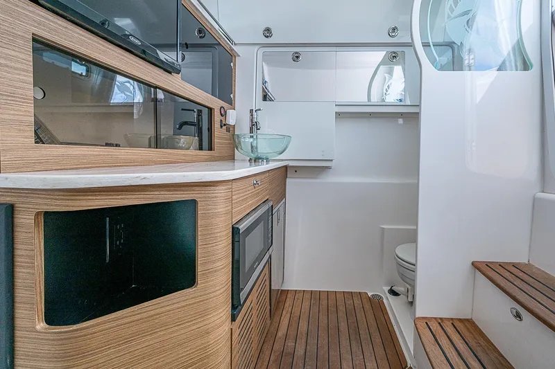 Riptide Yacht Photos Pics Luxurious interior of 2018 Everglades 435 Center Console boat with wood accents and modern amenities.