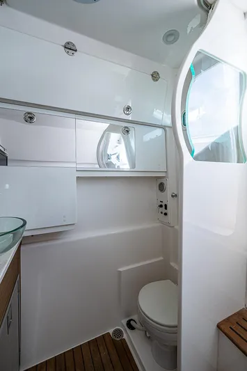 Riptide Yacht Photos Pics 2018 Everglades 435 Center Console boat bathroom with modern fixtures and wooden accents.