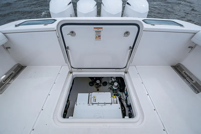 Riptide Yacht Photos Pics 2018 Everglades 435 Center Console boat with open hatch revealing engine compartment.