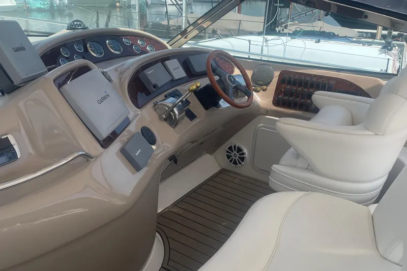  Yacht Photos Pics 2001 Sea Ray 460 Sundancer helm with Garmin navigation, luxurious seating, and wood accents.