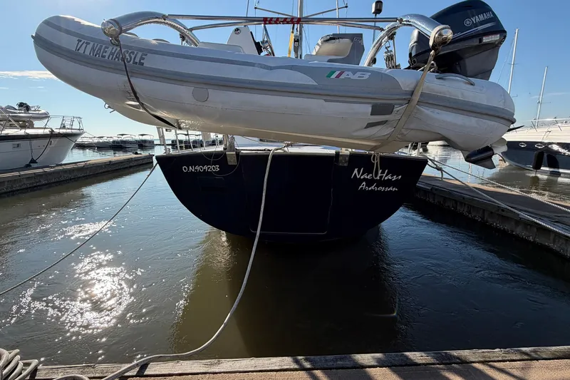 Nae Hassle Yacht Photos Pics Beneteau 57 yacht from 2004 docked with dinghy and Yamaha motor.