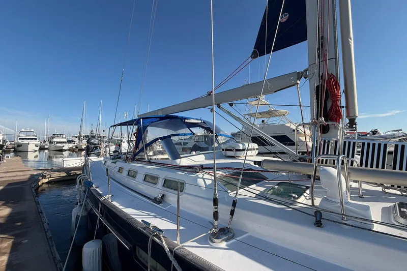 Nae Hassle Yacht Photos Pics Sailing yacht Beneteau 57, 2004 model, docked at marina under clear blue sky.