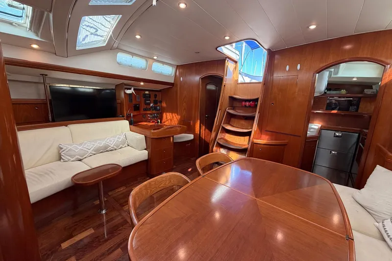 Nae Hassle Yacht Photos Pics Luxurious interior of 2004 Beneteau 57 yacht with elegant wood finish and modern amenities.
