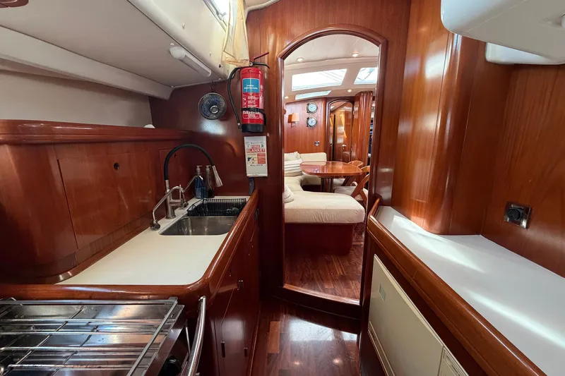 Nae Hassle Yacht Photos Pics Luxurious interior of 2004 Beneteau 57 yacht with wood finish and cozy seating area.