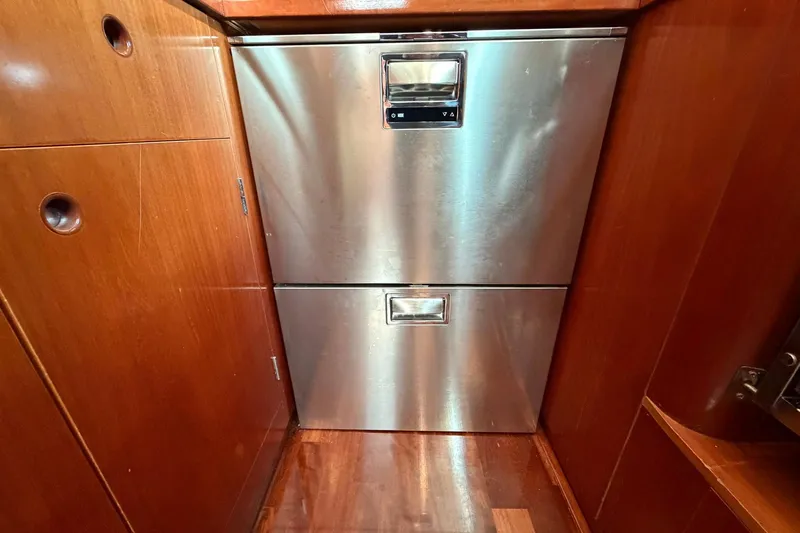 Nae Hassle Yacht Photos Pics Stainless steel drawers in 2004 Beneteau 57 yacht interior, surrounded by wooden cabinetry.