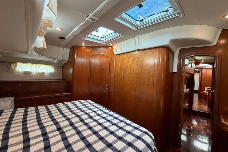 Nae Hassle Yacht Photos Pics Luxurious cabin interior of a 2004 Beneteau 57 yacht with wood finish and skylight.