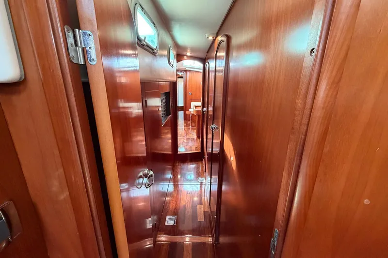 Nae Hassle Yacht Photos Pics Interior hallway of 2004 Beneteau 57 yacht with polished wooden finish.