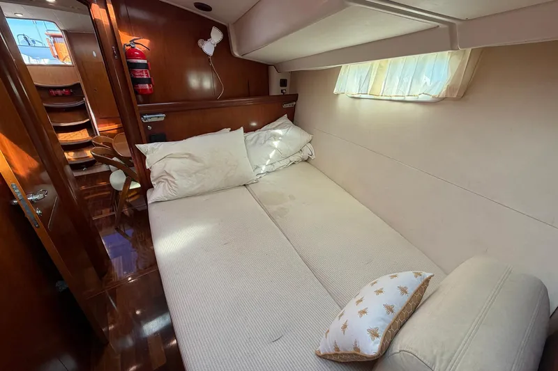 Nae Hassle Yacht Photos Pics Luxurious cabin interior of a 2004 Beneteau 57 yacht with cozy bedding.