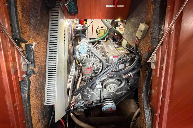 Nae Hassle Yacht Photos Pics Engine compartment of a 2004 Beneteau 57 sailboat, featuring a Yanmar engine.