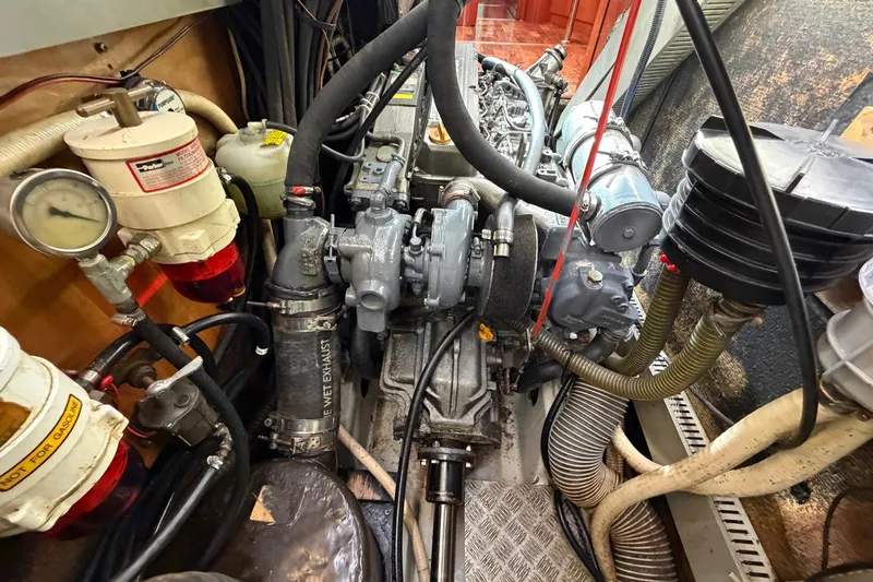 Nae Hassle Yacht Photos Pics Engine room of a 2004 Beneteau 57 yacht, showcasing mechanical components and hoses.