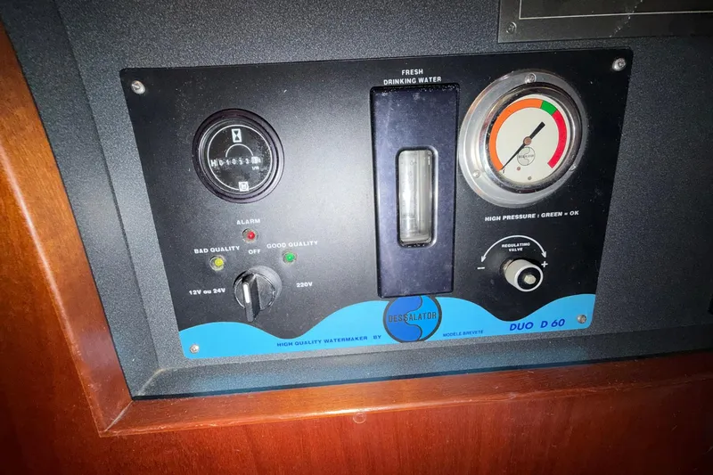 Nae Hassle Yacht Photos Pics Control panel of a 2004 Beneteau 57 yacht, featuring watermaker gauges and indicators.