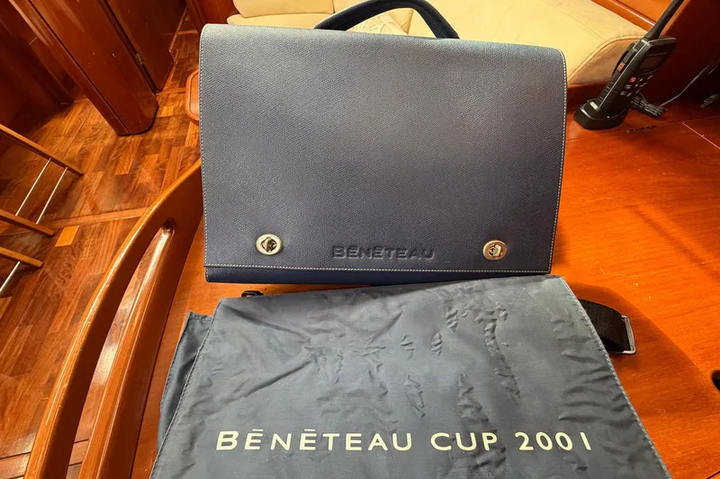 Nae Hassle Yacht Photos Pics Beneteau 57 yacht interior with branded bag and Beneteau Cup 2001 cover.