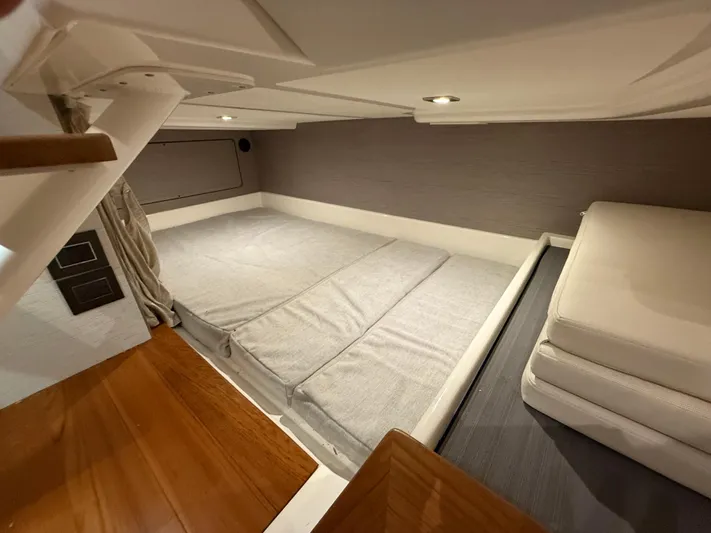  Yacht Photos Pics 2023 Tiara Yachts 43 LS cabin interior with modern bedding and wooden flooring.
