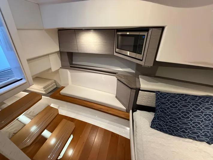  Yacht Photos Pics 2023 Tiara Yachts 43 LS interior with modern seating, wood flooring, and built-in microwave.