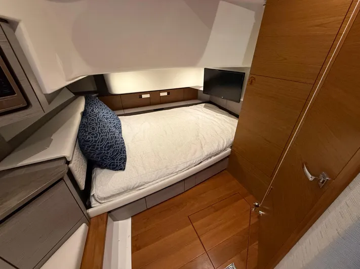  Yacht Photos Pics 2023 Tiara Yachts 43 LS cabin interior with bed, wooden flooring, and modern design.