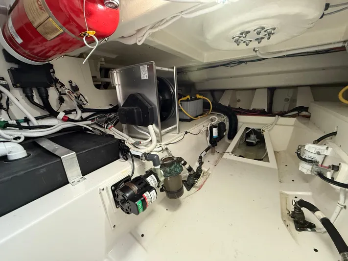  Yacht Photos Pics Engine room of 2023 Tiara Yachts 43 LS, showcasing mechanical components and fire extinguisher.