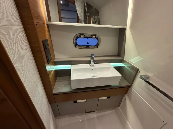  Yacht Photos Pics 2023 Tiara Yachts 43 LS bathroom with modern sink and porthole window.