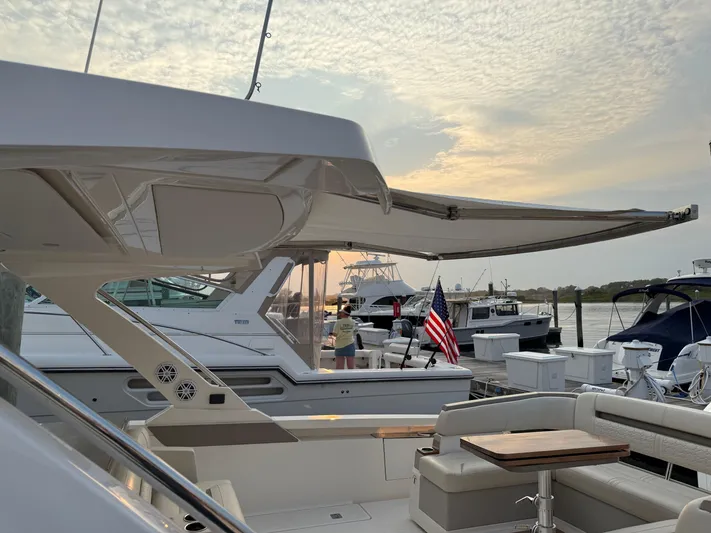  Yacht Photos Pics 2023 Tiara Yachts 43 LS at dock, featuring spacious deck and elegant design.
