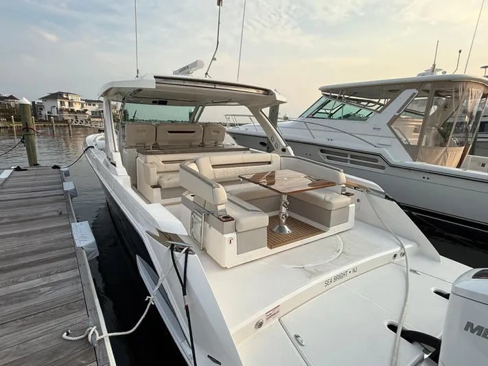  Yacht Photos Pics 2023 Tiara Yachts 43 LS luxury boat docked, featuring spacious seating and elegant design.