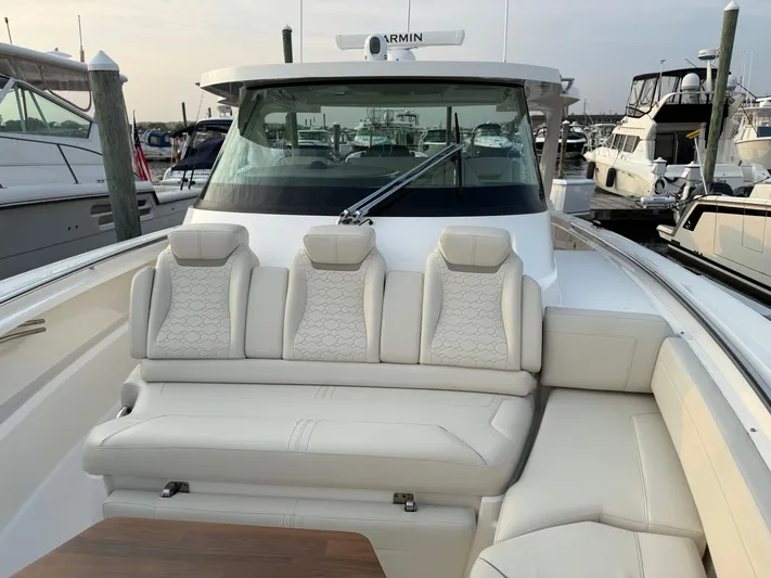  Yacht Photos Pics 2023 Tiara Yachts 43 LS luxury boat with plush seating at a marina.