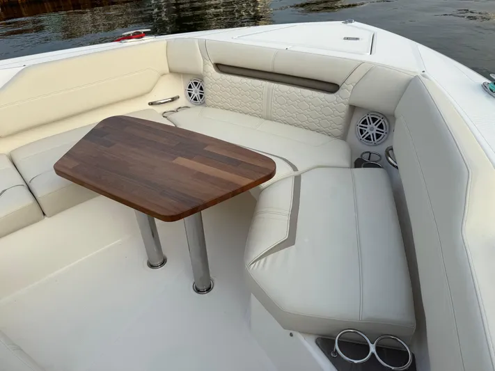  Yacht Photos Pics Luxurious seating area on 2023 Tiara Yachts 43 LS with elegant wooden table.