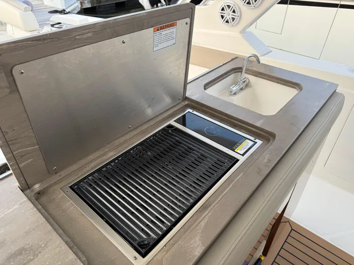 Yacht Photos Pics Outdoor kitchen on 2023 Tiara Yachts 43 LS, featuring a grill and sink.