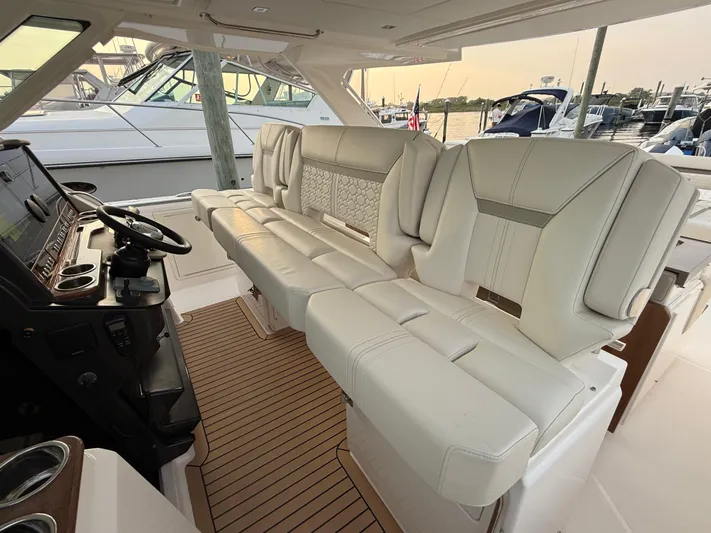  Yacht Photos Pics Luxurious interior of 2023 Tiara Yachts 43 LS with plush seating and modern helm.