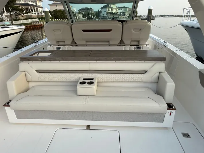 Yacht Photos Pics 2023 Tiara Yachts 43 LS luxury boat interior with plush seating and cup holders.