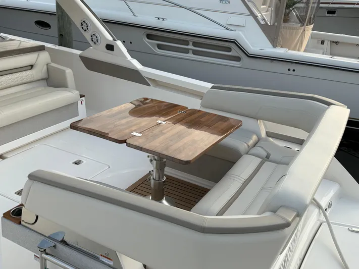  Yacht Photos Pics 2023 Tiara Yachts 43 LS interior with elegant seating and wooden table.