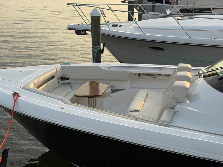  Yacht Photos Pics 2023 Tiara Yachts 43 LS docked, featuring sleek design and spacious seating area.