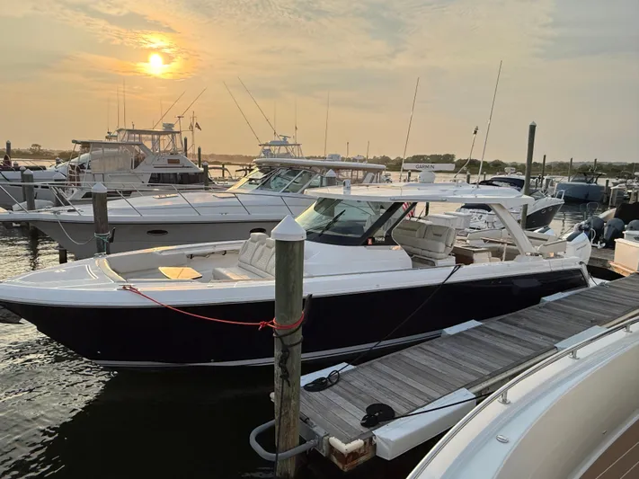  Yacht Photos Pics 2023 Tiara Yachts 43 LS docked at sunset, showcasing sleek design and luxury features.