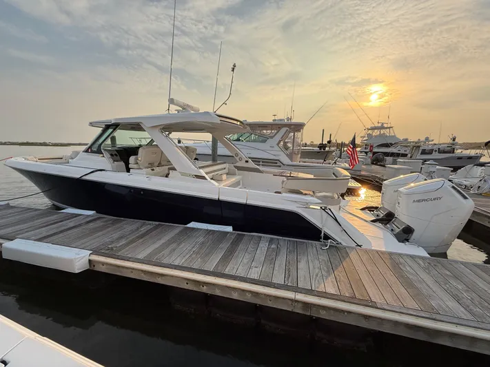  Yacht Photos Pics 2023 Tiara Yachts 43 LS docked at sunset, showcasing sleek design and luxury features.