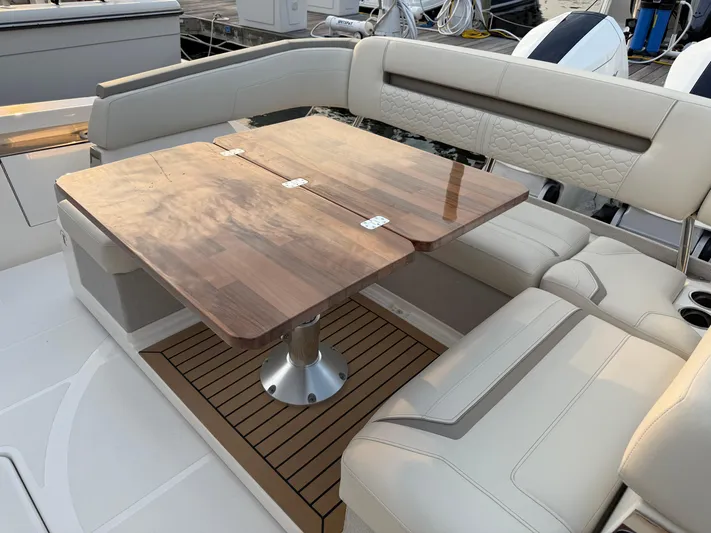  Yacht Photos Pics Luxurious seating area on 2023 Tiara Yachts 43 LS with elegant wooden table.