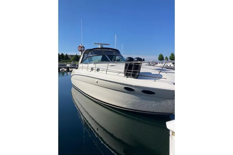 Lyman Zerga Yacht Photos Pics 2001 Sea Ray 380 Sundancer yacht docked in a marina under clear blue skies.
