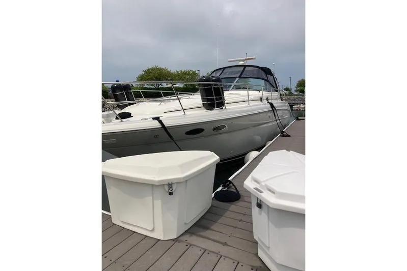 Lyman Zerga Yacht Photos Pics 2001 Sea Ray 380 Sundancer yacht docked with storage containers nearby.