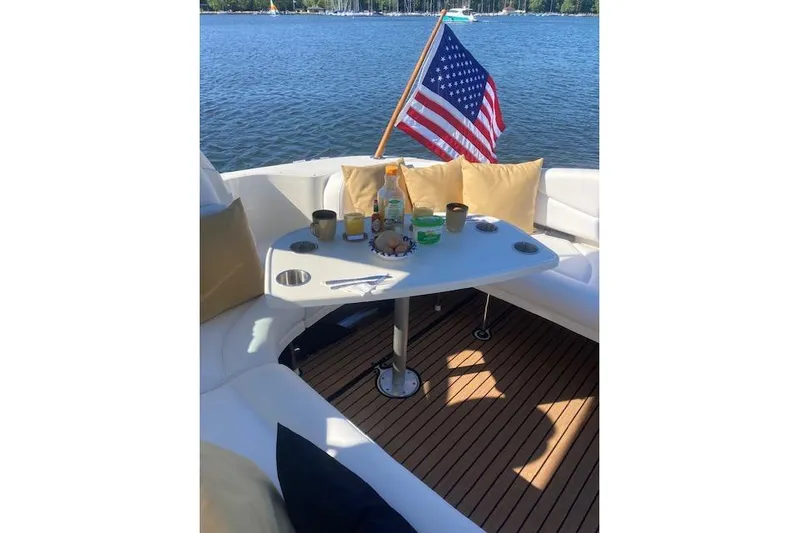 Lyman Zerga Yacht Photos Pics Cozy seating area on 2001 Sea Ray 380 Sundancer with American flag and refreshments.