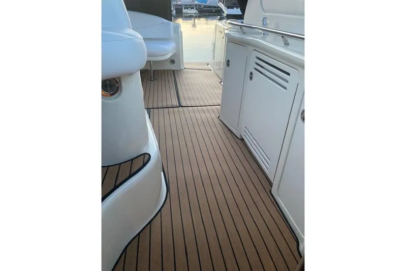 Lyman Zerga Yacht Photos Pics 2001 Sea Ray 380 Sundancer boat deck with sleek wood finish and white cabinetry.