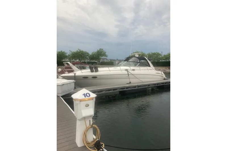 Lyman Zerga Yacht Photos Pics 2001 Sea Ray 380 Sundancer yacht docked at marina, cloudy sky background.