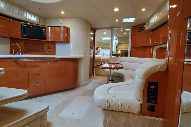 Lyman Zerga Yacht Photos Pics Luxurious interior of 2001 Sea Ray 380 Sundancer yacht with kitchen and seating area.