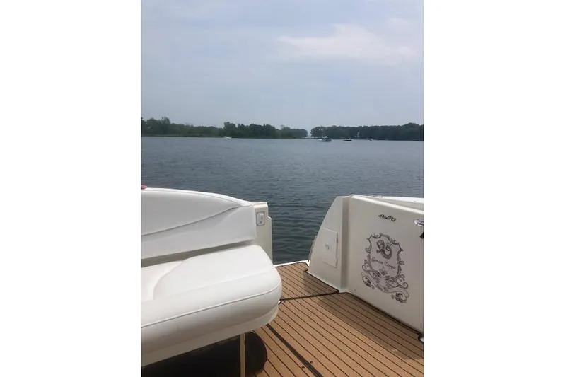 Lyman Zerga Yacht Photos Pics 2001 Sea Ray 380 Sundancer yacht on calm lake with scenic view.