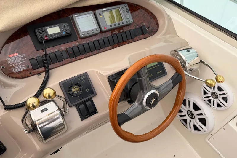 Lyman Zerga Yacht Photos Pics 2001 Sea Ray 380 Sundancer helm with wood steering wheel and control panel.