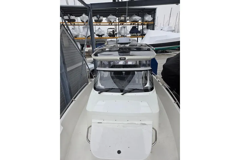 Ann #121 Yacht Photos Pics 2023 Nimbus T9 boat in storage, showcasing sleek design and modern features.