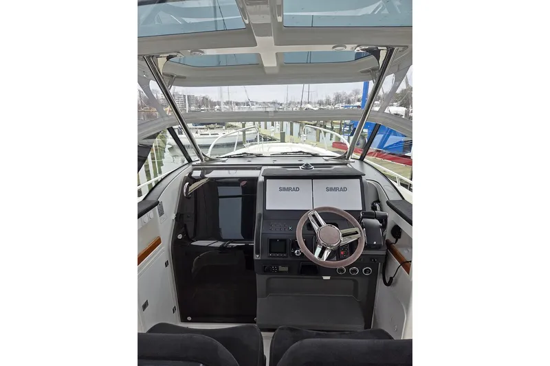 Ann #121 Yacht Photos Pics 2023 Nimbus T9 boat cockpit with dual Simrad displays and modern steering wheel.