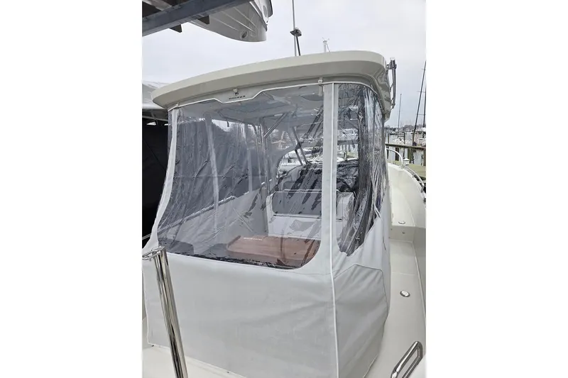 Ann #121 Yacht Photos Pics 2023 Nimbus T9 boat with clear protective enclosure at marina.