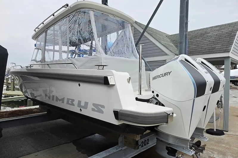 Ann #121 Yacht Photos Pics 2023 Nimbus T9 boat with dual Mercury engines on a dock.