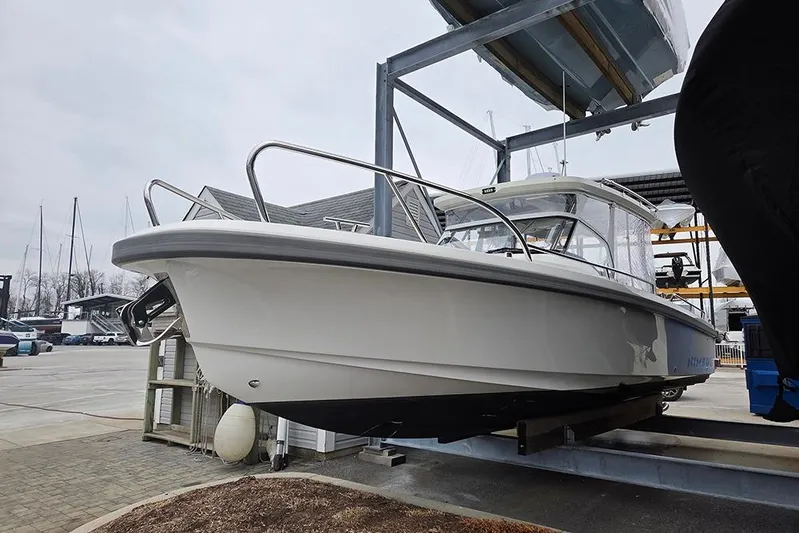 Ann #121 Yacht Photos Pics 2023 Nimbus T9 boat on a lift at a marina.