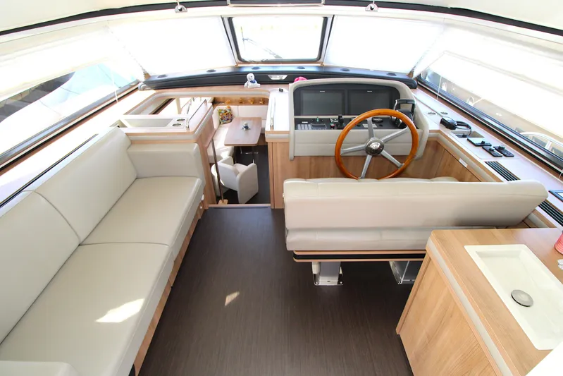 Yacht Photos Pics Luxurious interior of 2024 Linssen 55 SL AC Variotop yacht with modern helm and seating.